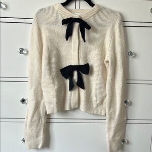 Elegant Cream Sweater with Black Bow Accents